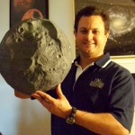Eric Vandernoot with a paper-mache' model of the asteroid Vesta.